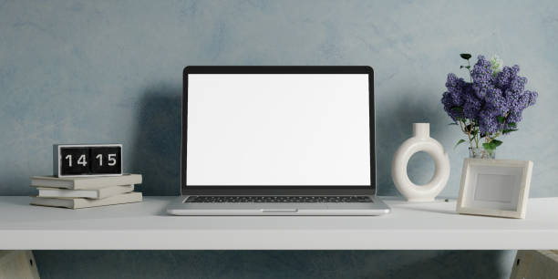 istock Minimalist workspace with a laptop mockup on a table in a minimal office. 3d render illustration 1702016080