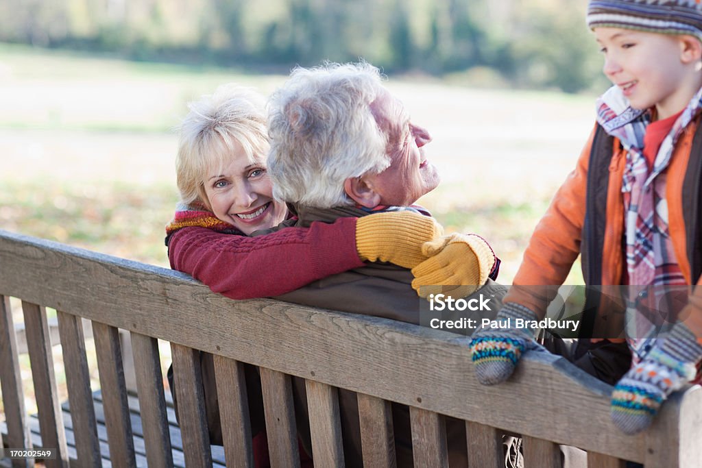 Grandparents playing in park with grandson  Autumn Stock Photo
