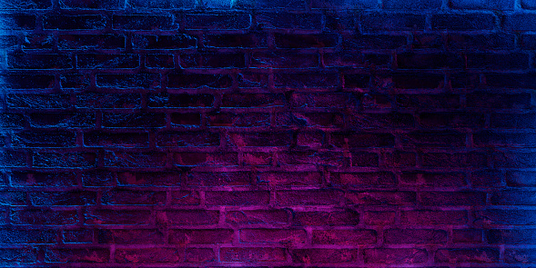 Neon brick wall background. Dark grunge textured empty space.
