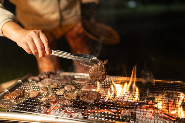 istock A woman grilling meat on barbecue at camp 1702038345