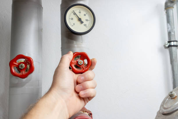 istock One hand turns the crane while heating, high heating costs in Europe 1702048299
