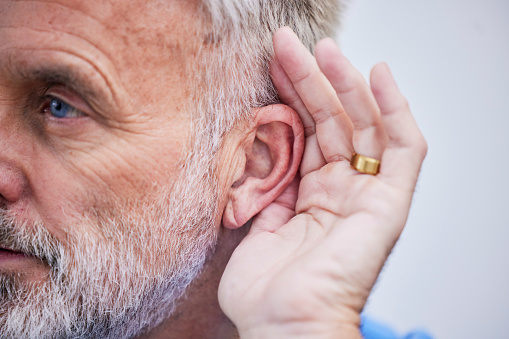 Senior man, listening and hand on ear or curious guy with gesture to hear gossip, conversation or announcement. Hearing, loss and old person with a disability or deaf male with hands to listen