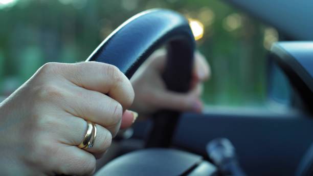 istock Car Dashboard and Female Hands Holding Steering Wheel During Driving Slow Motion 1702074065