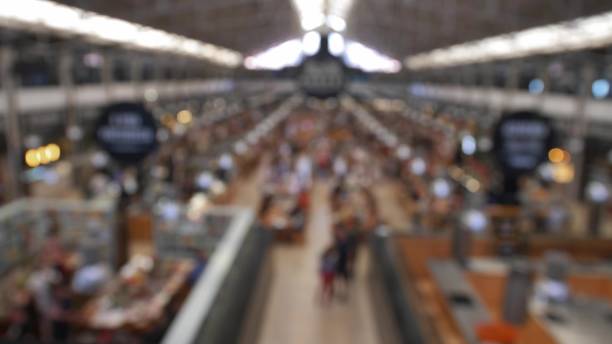 Anonymous Crowd in Food Hall Market Eating at Restaurant Tables