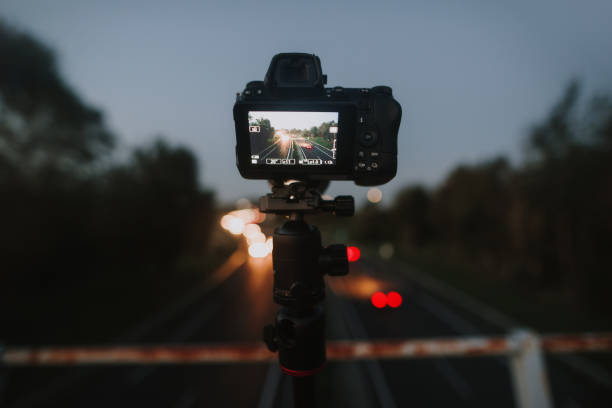 istock Camera on a tripod over a highway at night 1702086460
