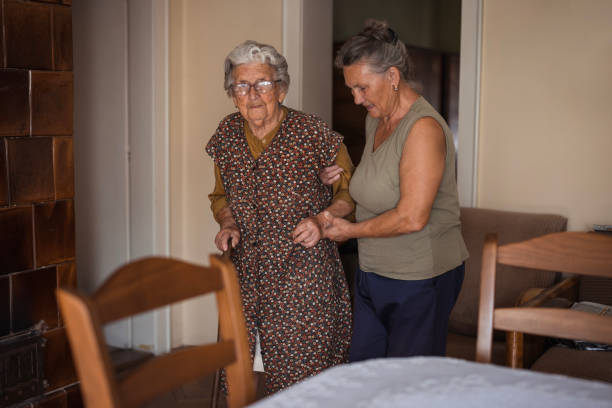 istock Caregiver assists elderly grandma with walking 1702086549