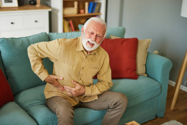 istock Senior man suffering from stomach ache at home 1702093622