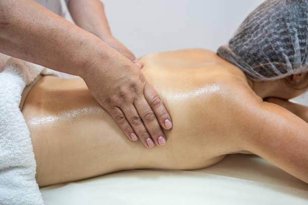 istock client receives physical therapy from a masseuse on her shoulders and back in a beauty spa. 1702098826