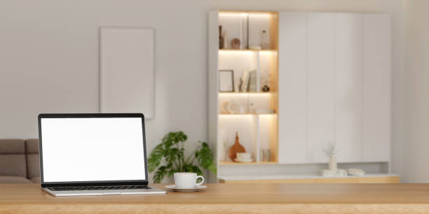 istock A laptop mockup on the table In minimal living room. on empty white wall background.3d render illustration 1702109629