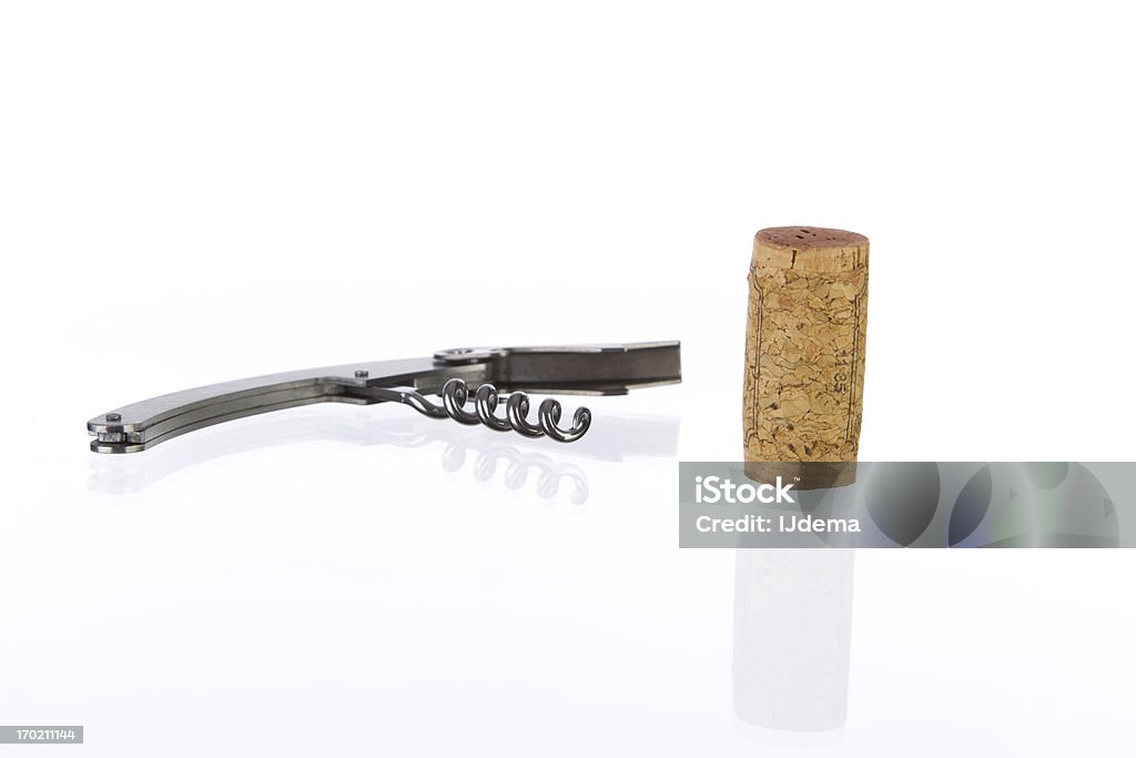 Cork and metal corkscrew Cork and metal corkscrew on a reflective surface against a white background Bottle Opener Stock Photo