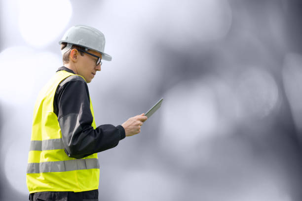 engineer with digital tablet	 on a gray background. - building contractor engineer digital tablet construction imagens e fotografias de stock