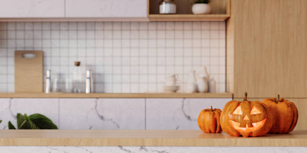 istock Pumpkin jack o'lantern on wooden table in kitchen, space for text. Halloween celebration. 3d render. 1702132869