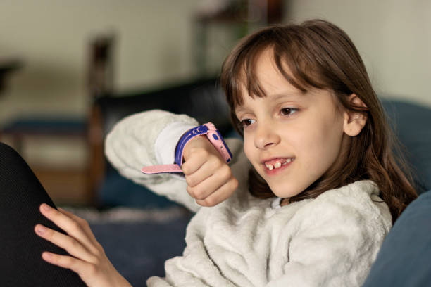 istock Elementary age girl talking on smart phone at home 1702140637