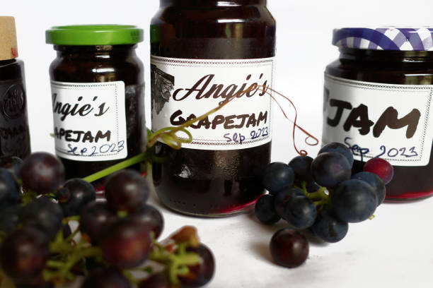 Homemade jam from dark red grapes out of the garden. Reuse of old glass jars