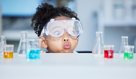 Science, learning and surprise with child in laboratory for experiment, education and research. Future, study and knowledge with face of young girl and chemicals for results, medicine and analysis