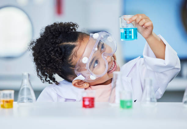 istock Science, learning and happy with child in laboratory for experiment, education and research. Future, study and knowledge with face of young girl and chemicals for results, medicine and analysis 1702150091