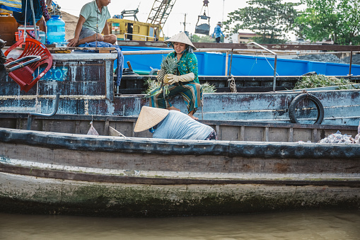 Can Tho, Vietnam - November 5, 2022: female vietnamese merchants on boats at floating market in Can Tho, Mekong Delta, south vietnam