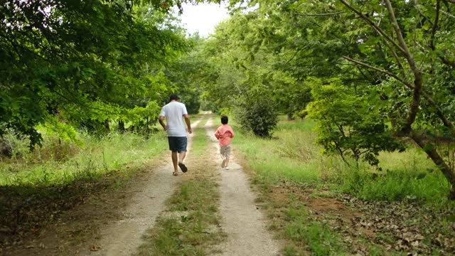 Little boy walking with father