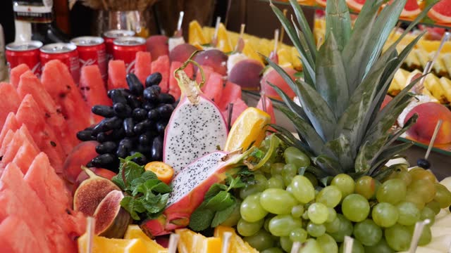 Festive fruit buffet. Decoration of the buffet table. Grapes, pineapple, orange and other fruits.