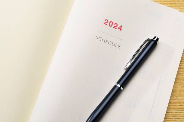 istock 2024 Notebook and pen on wooden table (2024 schedule book) 1702182347