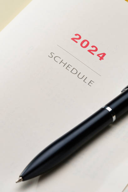 istock 2024 Notebook and pen on wooden table (2024 schedule book) 1702182849