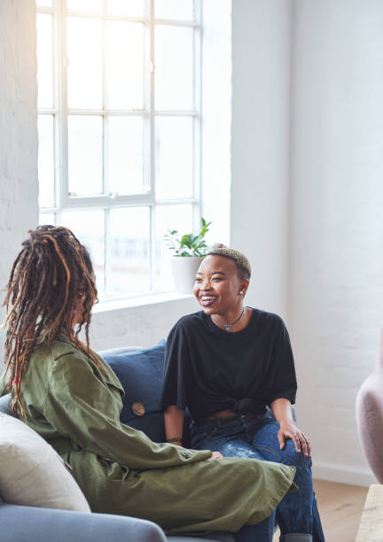 istock two woman friends talking having conversation sitting on sofa at home 1702195075