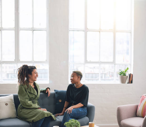 istock two woman friends talking having conversation sitting on sofa at home 1702195079