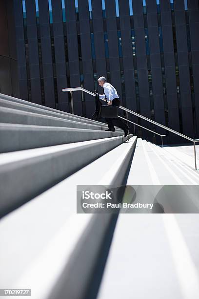 Businessman Rushing Up Steps Outdoors Stock Photo - Download Image Now - Staircase, Moving Up, Running