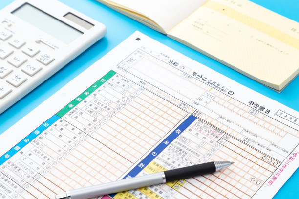 istock Japanese tax return form on a blue background. 1702204926
