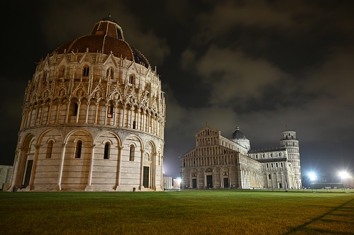 Baptistery of Pisa at night with Our Lady of the Assumption Cathedral and the leaning tower in the background