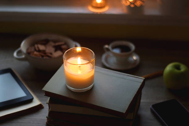 Books, Glasses, Tablet, Phone, Cookies, Drink, Apple and Candles stock photo