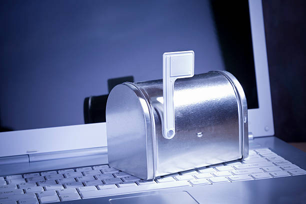 You've Got Mail. Miniature silver mailbox on white laptop. You've Got Mail. Miniature silver mailbox on white laptop. junk mail photos stock pictures, royalty-free photos & images