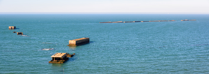 Tracy-sur-Mer, France - Sept. 4, 2023: Panoramic view of the remains of Phoenix concrete caissons from the Mulberry harbour, an artificial port built on Gold Beach after the Normandy landings in WWII.