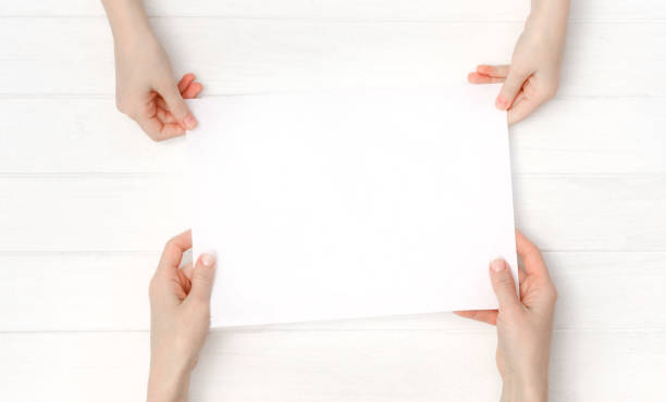 istock Empty blank sheet of paper in hands 1702250952
