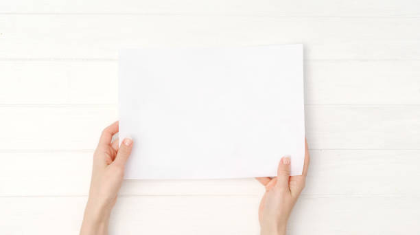 istock Empty blank sheet of paper in hands 1702250953