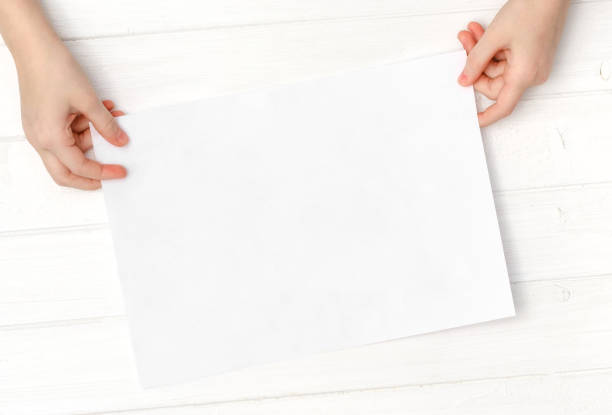 istock Empty blank sheet of paper in hands 1702250958