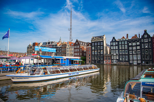 Amsterdam, Netherlands - 26 July, 2023: Gingerbread dancing houses along Singel water canal in Amsterdam city