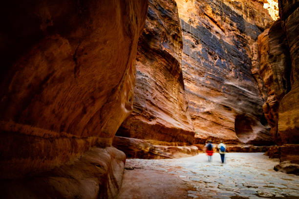 istock Group of tourists between rocks, Jordan 1702259862