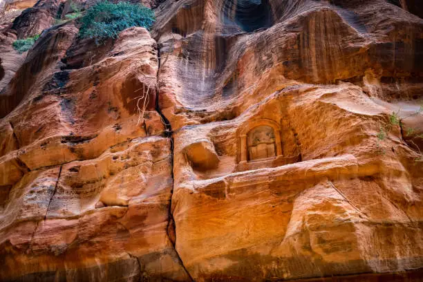 Ancient carvings inside the greened sandstone rock in Petra, Jordan