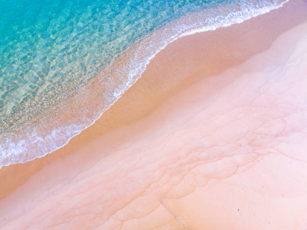 istock Waves crashing on sandy shore,Sea ocean waves background 1702265511