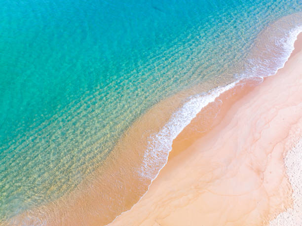 istock Waves crashing on sandy shore,Sea ocean waves background 1702265549