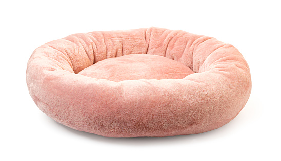 Pink soft round plush pet bed isolated on white
