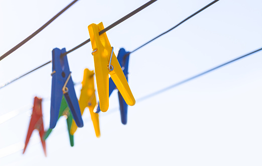 Colorful  clothespins on the hangers. Plastic clothespins in different colors. with copy space
