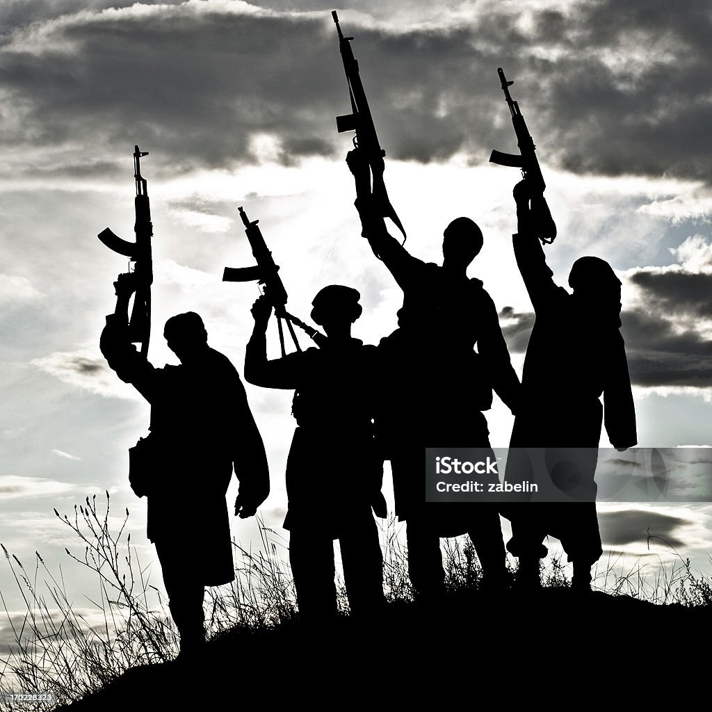 Silhouette of Muslim militants with rifles Silhouette of several muslim militants with rifles Terrorism Stock Photo