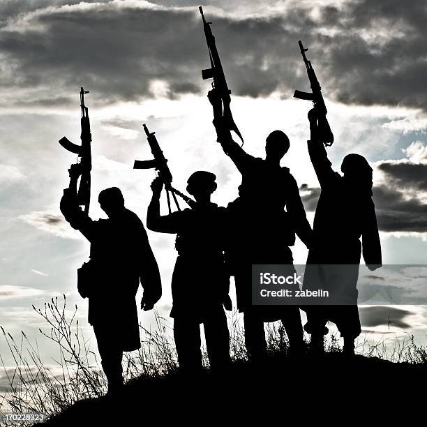 Silhouette Of Muslim Militants With Rifles Stock Photo - Download Image Now - Terrorism, Militant Groups, In Silhouette