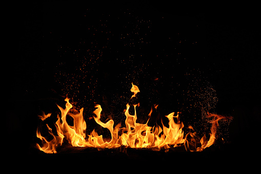 the beautiful flames of a gas fire isolated against a black background. 