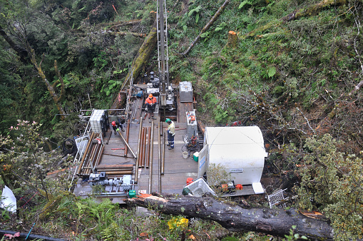 Pike River, New Zealand, March 1, 2014: Men pause for lunch while drilling into the 2 km entrance tunnel of the Pike River Coal Mine in preparation for the recovery of 29 miners who died in an explosion. No cameras were allowed to operate while the rig was working.