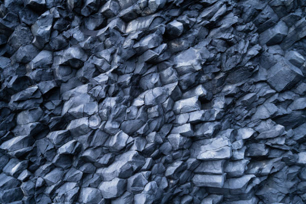 istock Basalt stones as a background. Image for background and wallpaper. Sharp rocks. Photography for design. Textures in nature. 1702334605