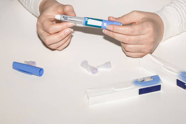 istock Woman holding an injection pen for diabetic. 1702335302