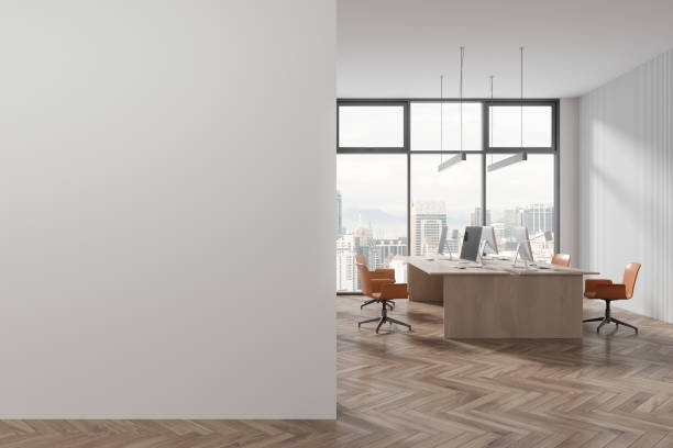 istock White coworking room interior with pc computer on table in row, mock up wall 1702338076